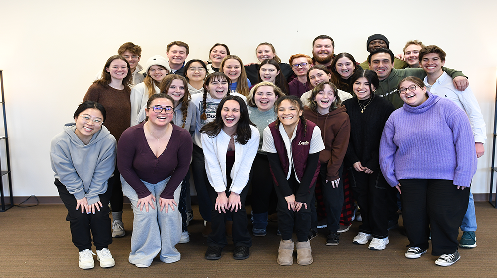 Group of students clustered together smiling