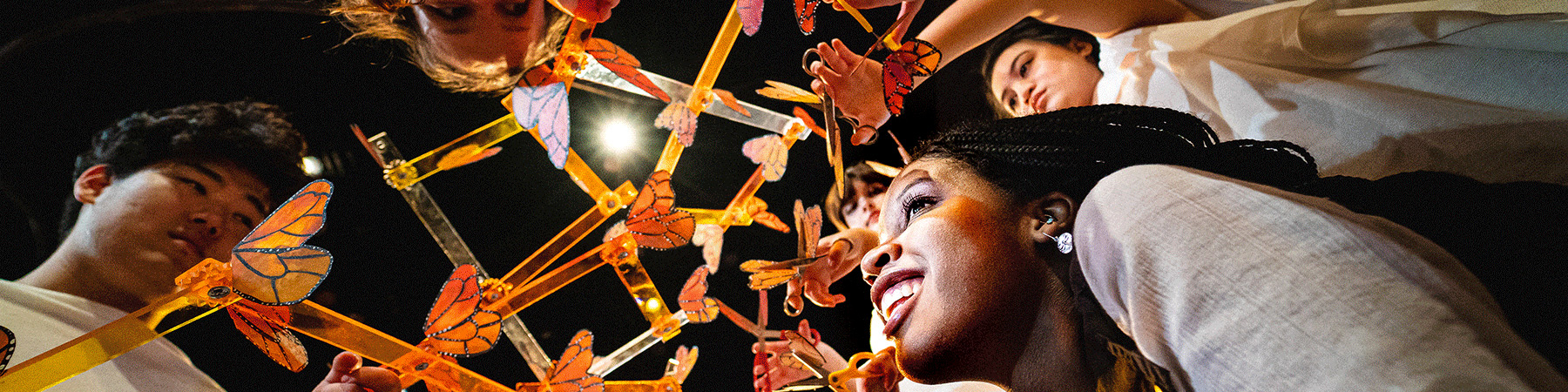 Loyola University Chicago students build an art piece involving items resembling butterflies