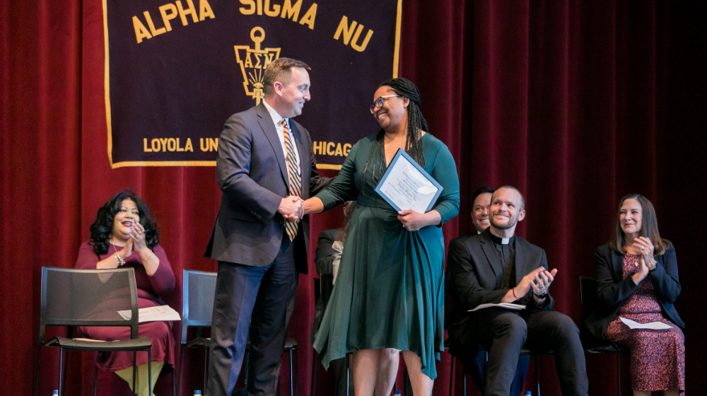Alpha Sigma Nu induction 2023, Dr. Reed congratulating Dr. Newell.