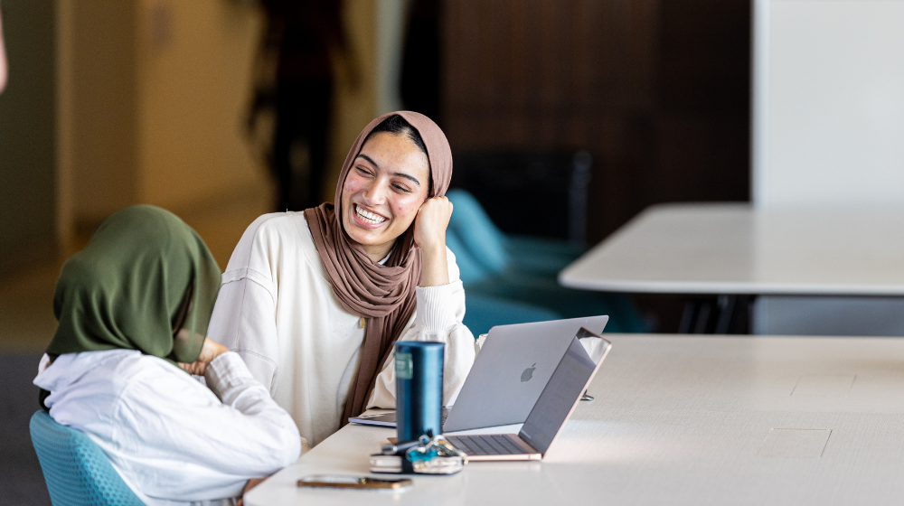 Students sit together happily.