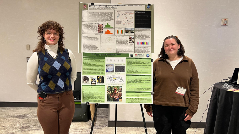 Katarina Alvarado and a peer present their posters.