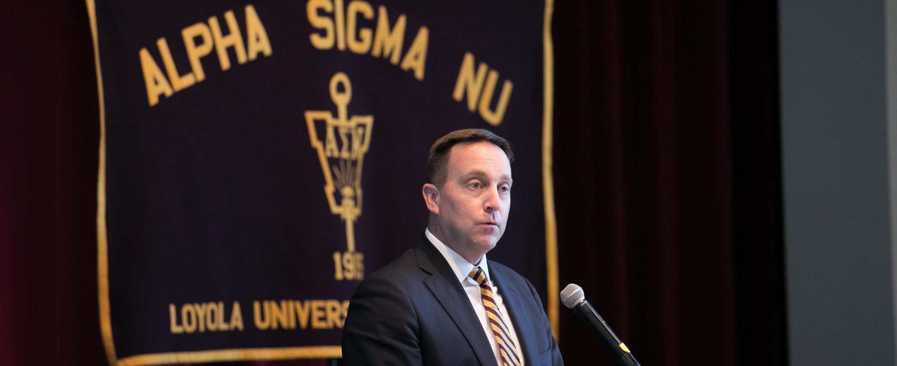President Mark Reed speaks to inductees of the Alpha Sigma Nu Honor Society.
