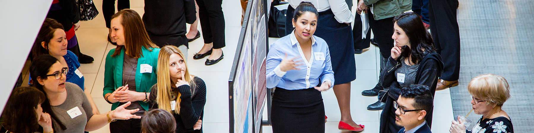 Graduate students converse at The School of Education Research Symposium