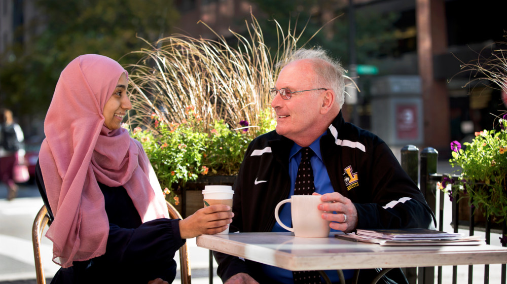 Jerry Overbeck, S.J., chats with Weekend JD student Amina Jaffer-Mohsin.