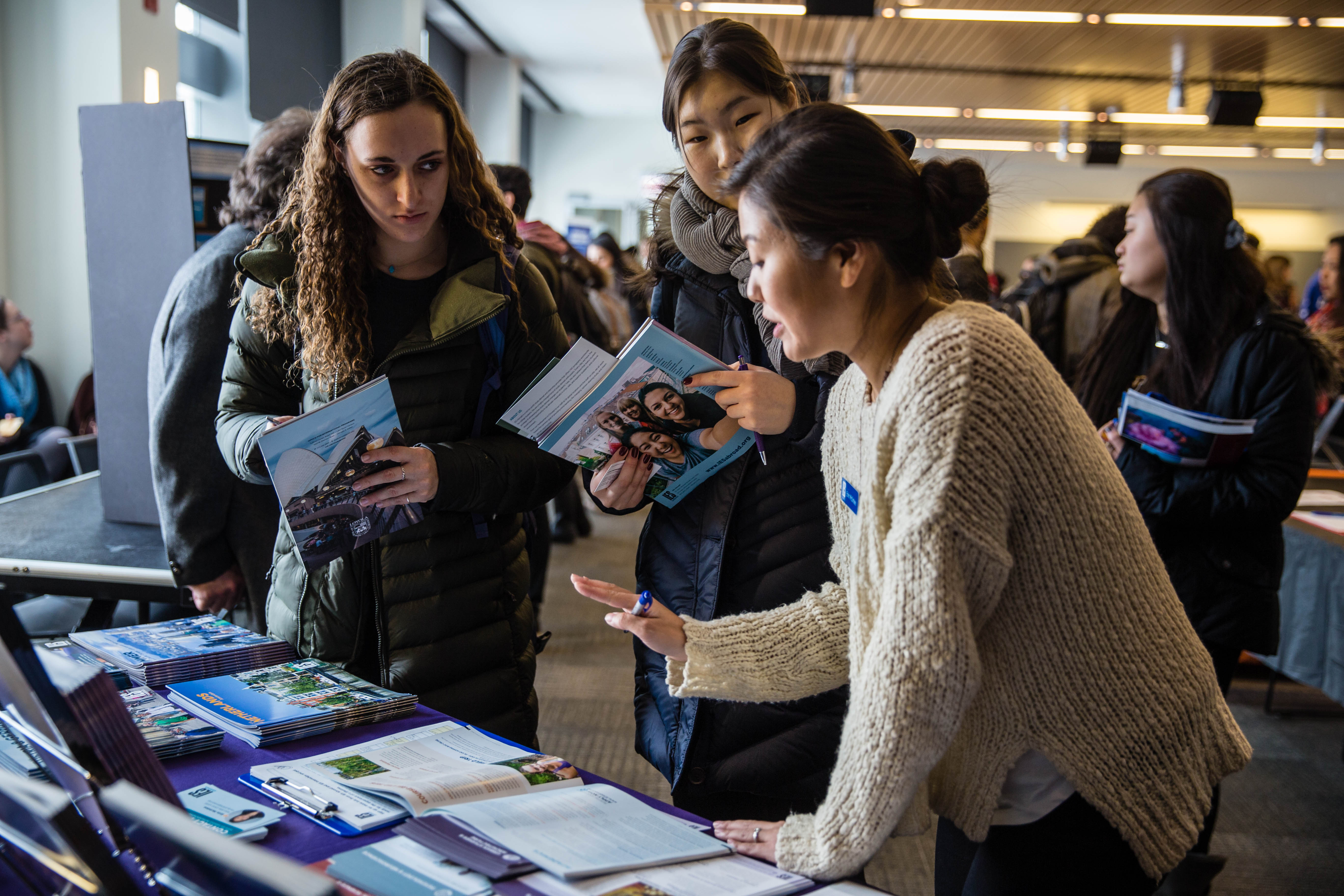 Students looking at a Study Abroad brochure