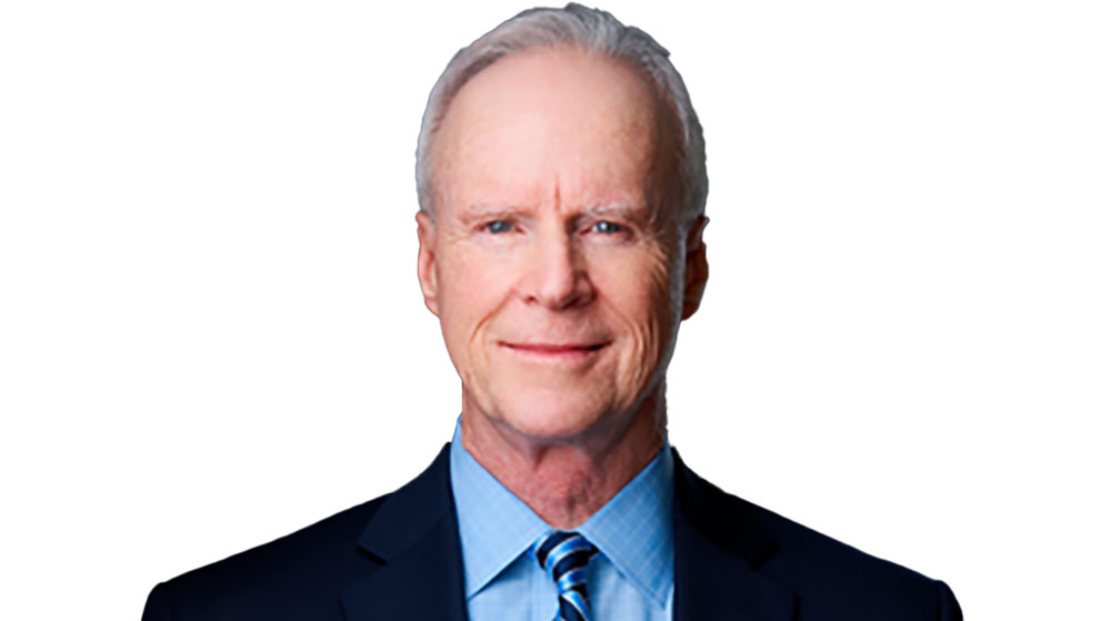 Prof. Cliff Shultz smilling in a suit and tie